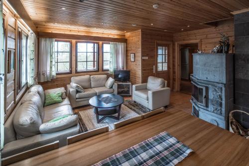 a living room with a couch and a fireplace at Tundrea Holiday Resort in Kilpisjärvi