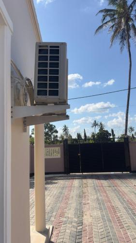 a air conditioner on the side of a house at Abode of peace Airport stay in Dar es Salaam