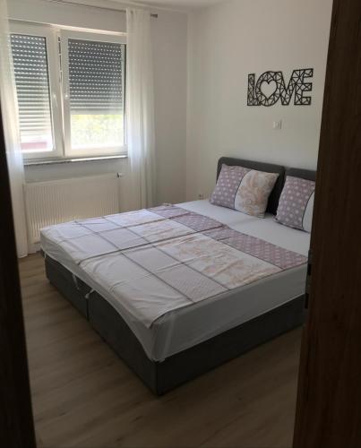 a bedroom with a bed in a room at Apartman SLAVONIA 4 in Đakovo