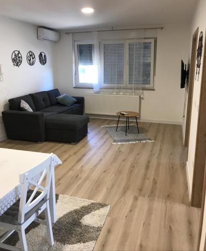 a living room with a couch and a table at Apartman SLAVONIA 4 in Đakovo