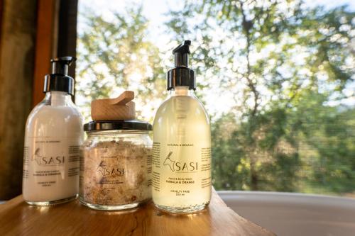 three bottles sitting on a table with a window at Sasi Africa Luxury Tented Bush Lodge in Bergville