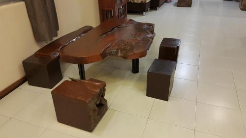 a wooden bench sitting on top of a floor at Rose Apartment Kea Farm in Cameron Highlands