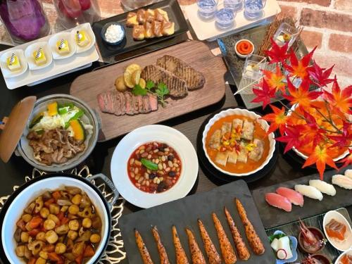 a table topped with lots of different types of food at Biei Shirogane Onsen Hotel Park Hills in Biei
