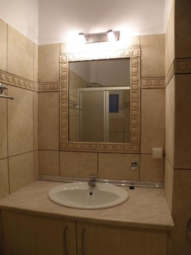 a bathroom with a sink and a mirror at Kate Apartments in Kokkari