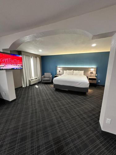 a hotel room with a bed and a flat screen tv at Comfort Inn Dallas Park Central in Dallas
