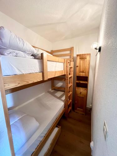 a small room with two bunk beds in it at Studio station Puy-Saint-Vincent 1700 in Puy-Saint-Vincent