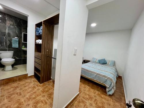 a bedroom with a bed and a bathroom with a toilet at Casa Blanca Acolman Ideal for 10 people in Acolman de Netzahualcóyotl