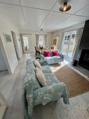 a living room with a couch and a fireplace at Old Oak Tree Cottage in Rydal
