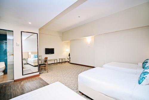 a hotel room with a bed and a bathroom at Kingston Hotel 10 - Bukit Jalil in Serdang