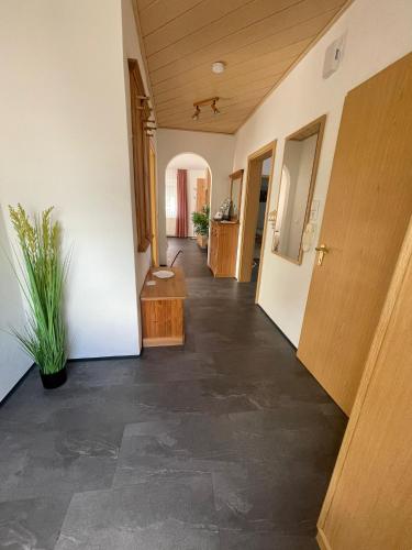 an empty hallway of a house with a door and a plant at Country Style meets Modern in Selb