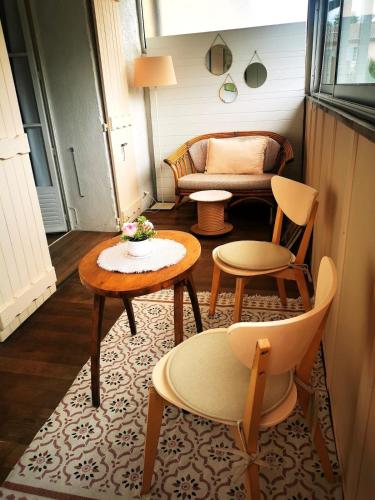 a living room with two tables and a couch at Beautiful studio in Vidauban