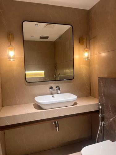 a bathroom with a sink and a mirror at FHotels in Bengaluru