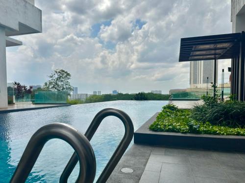 a view of a swimming pool in a building at Mid Vally Southkey JB, 2BR, WIFI, 7 mins to CIQ , 5-7pax in Johor Bahru