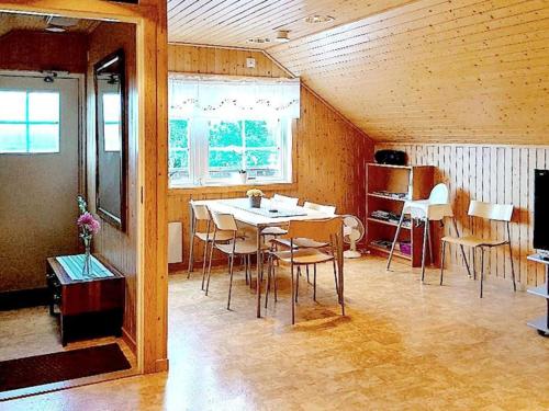 a dining room with a table and chairs and a mirror at 5 person holiday home in LAMMHULT, SVERIGE in Förhult