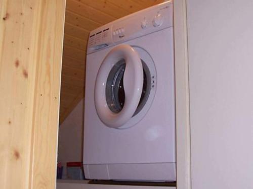 a washing machine with a white door in a kitchen at 5 person holiday home in LAMMHULT, SVERIGE in Förhult
