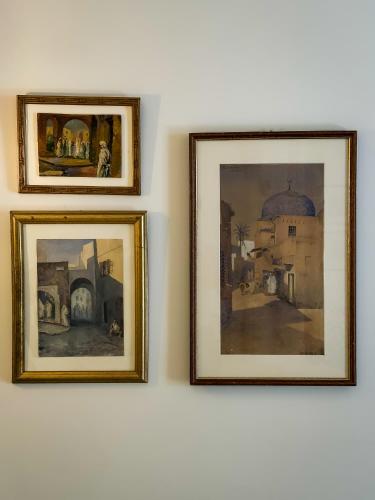 three framed paintings hanging on a wall at Dar Ben Turkia in Tunis