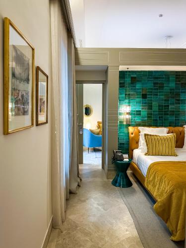 a bedroom with a bed and a green tile wall at Dar Ben Turkia in Tunis