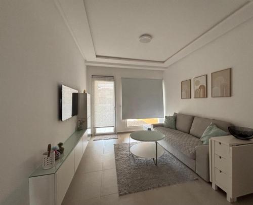 a living room with a couch and a table at Mirador Golf 3 cappuccino in Cabo Negro