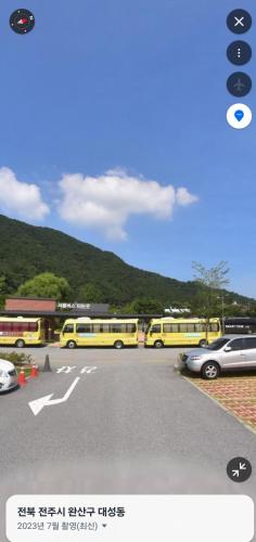 a group of yellow buses parked in a parking lot at Jeonju Hanok Little Prince in Jeonju