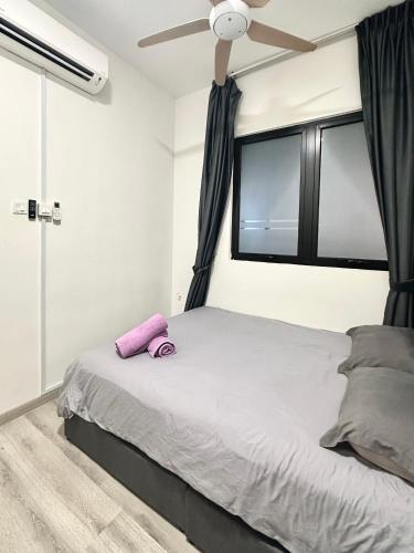 a bedroom with a bed with a ceiling fan at Mid Vally Southkey JB, 2BR, WIFI, 7 mins to CIQ , 5-7pax in Johor Bahru