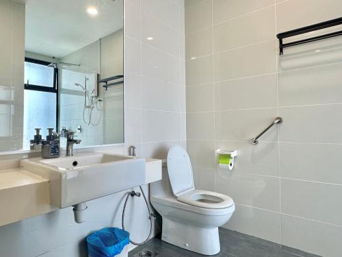 a white bathroom with a toilet and a sink at Mid Vally Southkey JB, 2BR, WIFI, 7 mins to CIQ , 5-7pax in Johor Bahru