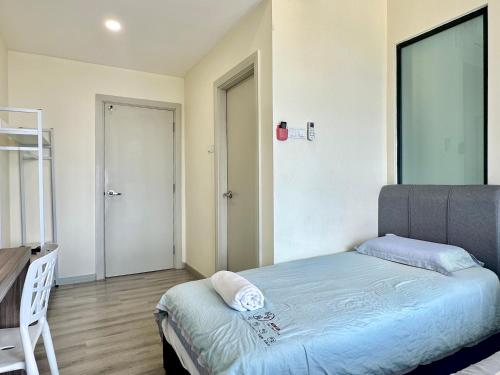 a small bedroom with a bed and a chair at Mid Vally Southkey JB, 2BR, WIFI, 7 mins to CIQ , 5-7pax in Johor Bahru