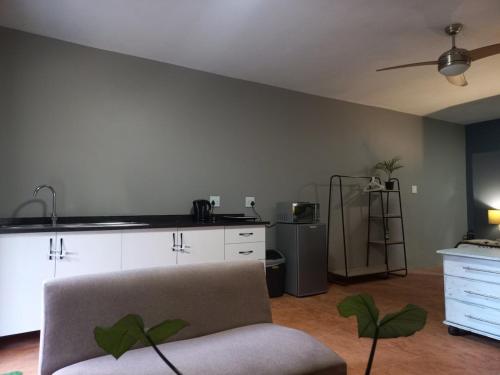 a living room with a couch and a kitchen at Shaka's Rest Studio Two in Mount Moreland