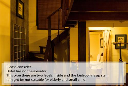 a picture of a room with a stair case at Arun Residence in Bangkok