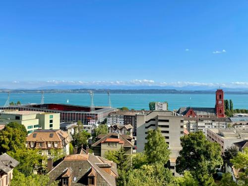a city with a view of the water and buildings at Bellavista in Neuchâtel