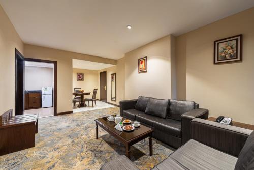 a living room with a couch and a table at Razana Al Rawdha Hotel in Makkah