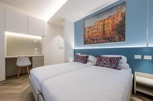 two beds in a room with a painting on the wall at Albergo Ristorante Corsini in Pavullo nel Frignano