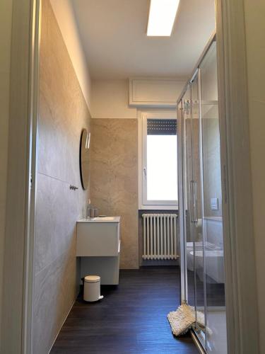 a bathroom with a sink and a glass shower at Top Stay Retrò in Costa Volpino