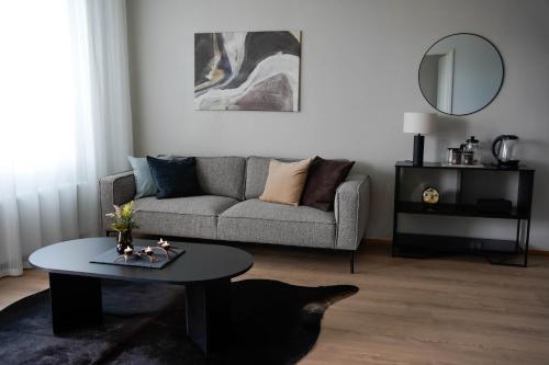 ein Wohnzimmer mit Couch und Tisch in der Unterkunft Premium Apartment With Sauna & Parking - Lapnest in Rovaniemi