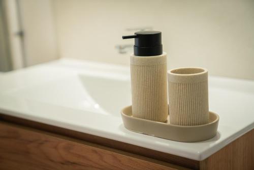 two rolls of toilet paper sitting on a bathroom counter at Bel appartement vue mer - Mafat'appart in La Possession