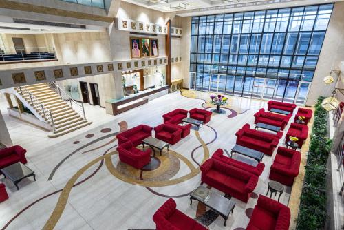 an overhead view of a waiting room with red chairs at Razana Al Rawdha Hotel in Makkah