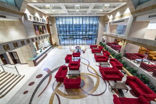 an overhead view of a lobby with red chairs at Razana Al Rawdha Hotel in Makkah