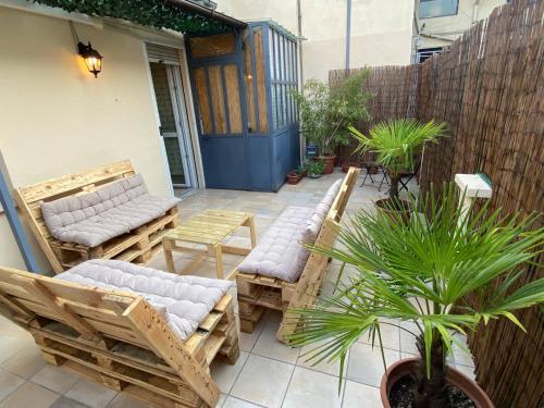 a patio with chairs and a table and a plant at Alfieri Panorama in Asti