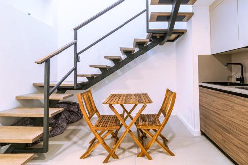 a kitchen with a table and two chairs and a staircase at Luxury Rooms Terrazza Sette in Split