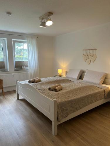 a bedroom with a large bed with two pillows on it at Ferienwohnung II im idyllischen Gulfhof in Krummhörn