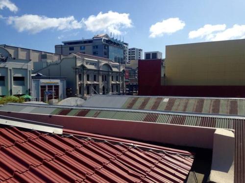 a view of a city with buildings and a roof at The Nest - Central and Sunny Wellington Loft in Wellington