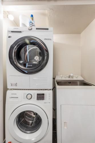 a washer and dryer in a small kitchen at The Nest - Central and Sunny Wellington Loft in Wellington