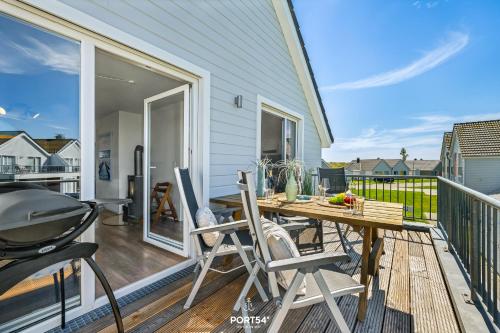 a patio with a grill and a table and chairs at Ferienwohnung Nicks Seestern Olpenitz in Olpenitz