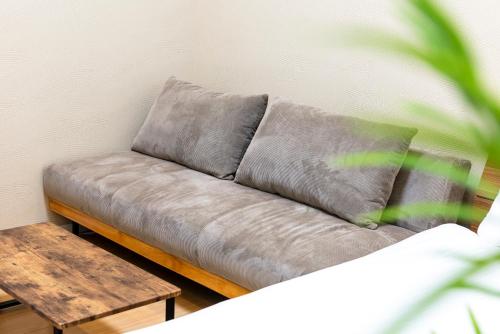 a couch sitting in a room with a table at LOOP Shimogofuku in Fukuoka