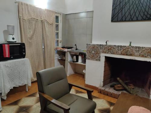 a living room with a chair and a fireplace at Miraflores 2- Calor de Hogar in Asuncion