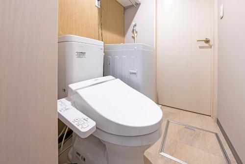 a bathroom with a white toilet in a room at LOOP Shimogofuku in Fukuoka