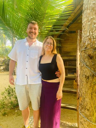 a man and a woman standing next to a tree at Secret Paradise Panama in Panama