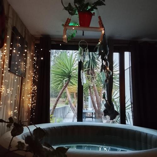 a room with a tub in front of a window at Alojamento 444 in Monção