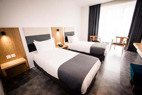 Кровать или кровати в номере Ingate Hotel
