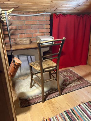a chair sitting at a table with a book at Kircher Hütte in Diex