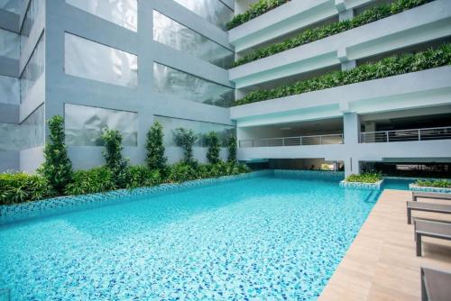 an apartment building with a swimming pool at Neu Suites KL with Daily Breakfast Included in Kuala Lumpur